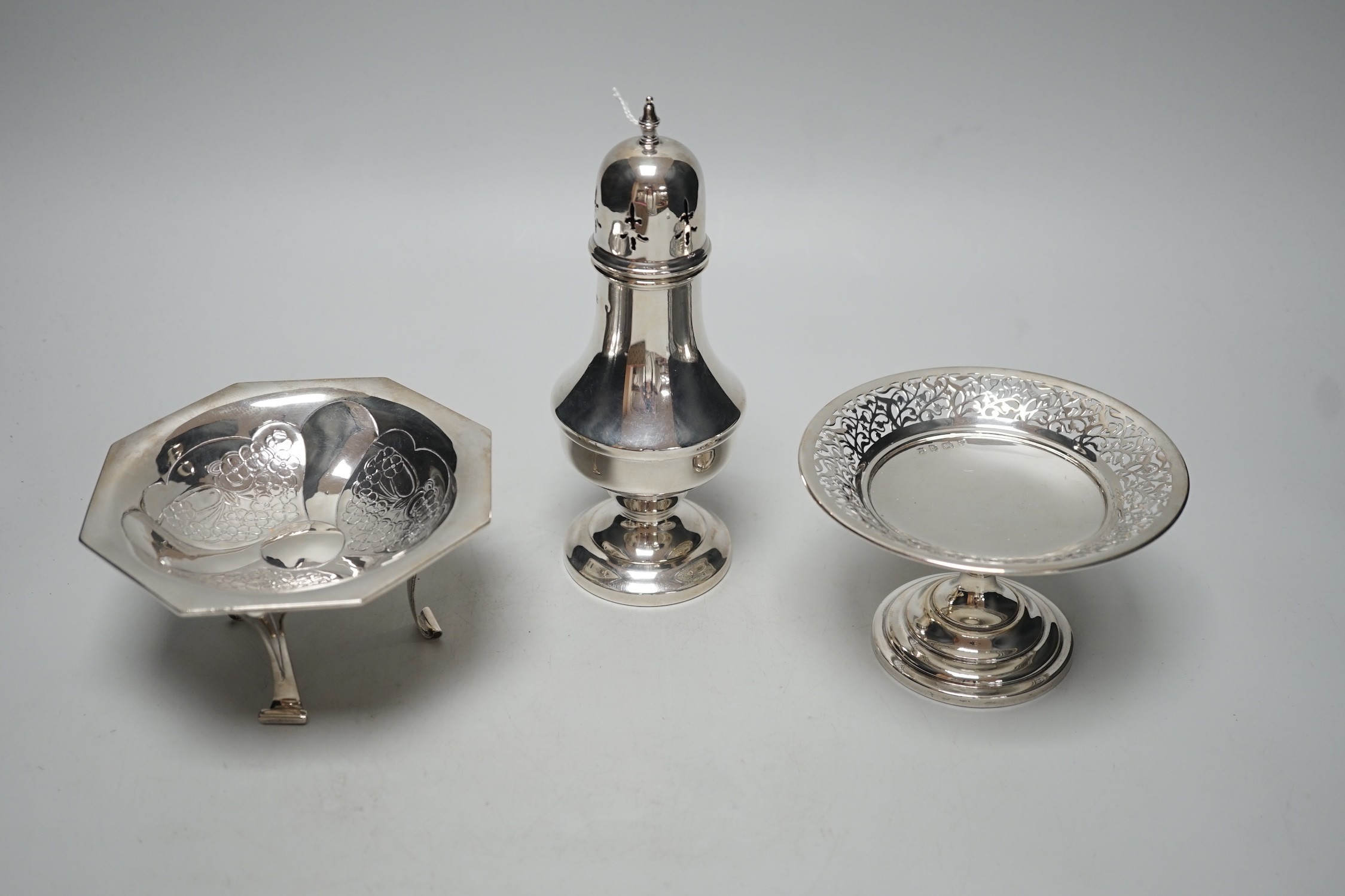 An Art Nouveau silver tripod bowl, by W.G. Connell, London, 1901, diameter 13cm, a later silver pedestal dish and modern silver sugar caster, 19cm, 11.4oz.